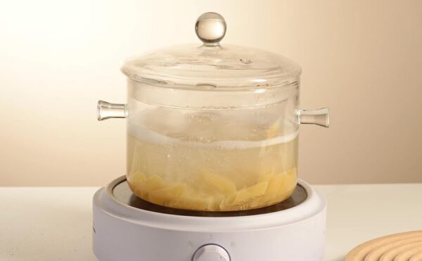 Clear Glass Cooking Pot With Lid And Brush And Silicone Hot Pads On Stove. - Image 2